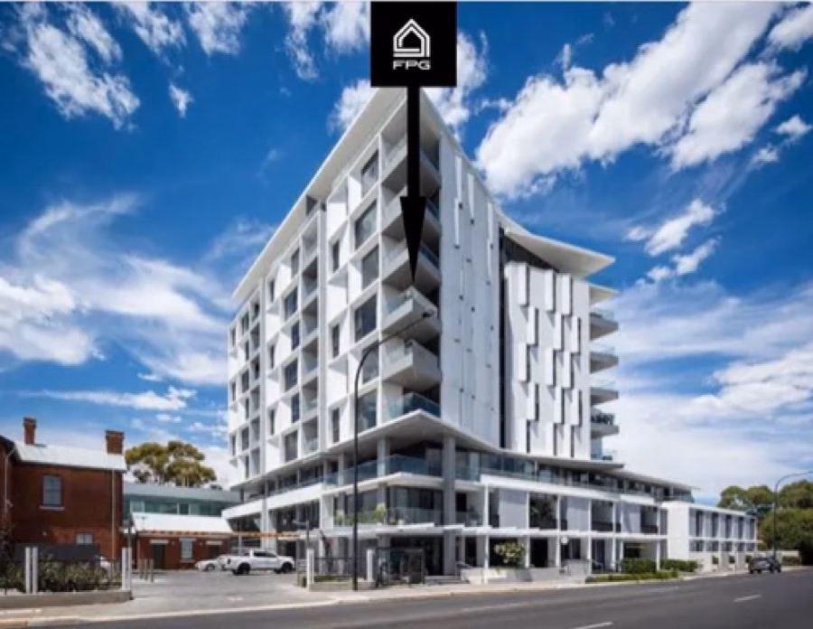 White apartment building with curved balconies